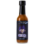 A bottle of Stanky Sauce Sweet Jalapeño Reaper Hot Sauce with a black cap and a black label featuring a dark blue haired cartoon monkey mascot, set against a plain white background.
